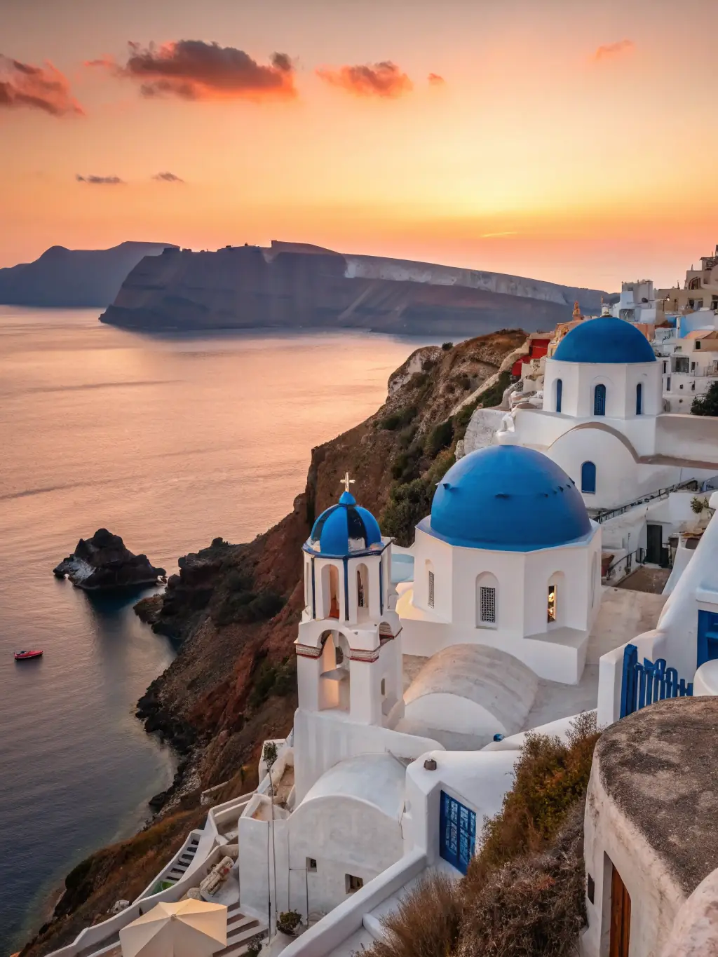 A stunning aerial view of Santorini, Greece, showcasing its white-washed buildings, blue domes, and the Aegean Sea.