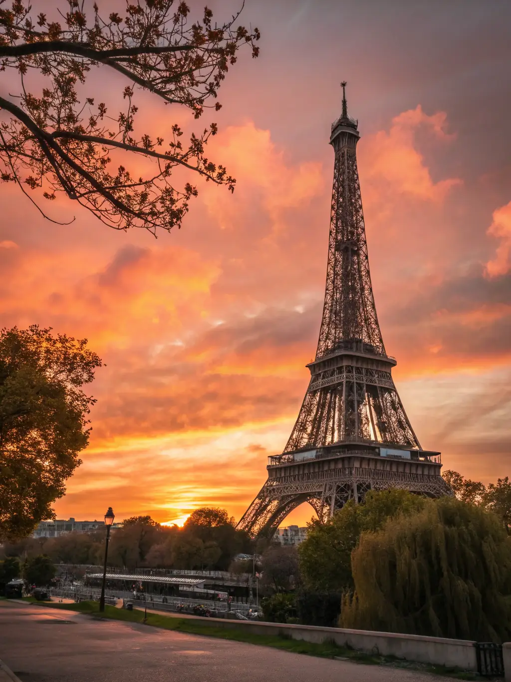 A vibrant image of the Eiffel Tower in Paris at sunset, with tourists strolling along the Seine River, capturing the romantic essence of the city.